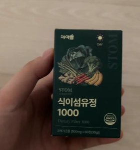 스톰 식이섬유정 1000 상자를 손에 들고 있는 사진